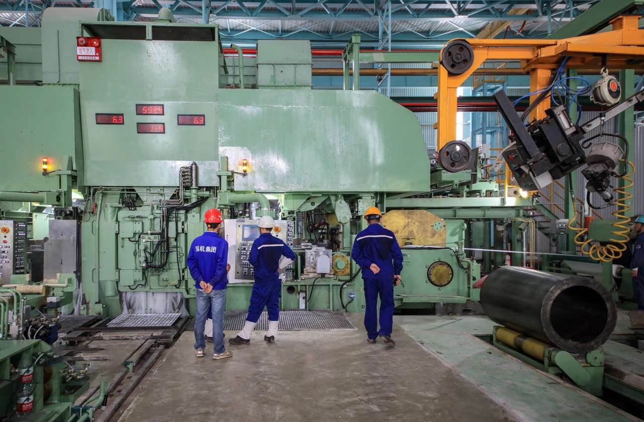 Stainless steel coil processing line at MFY factory with automated loading system and staff inspection, showcasing integrated production capacity
