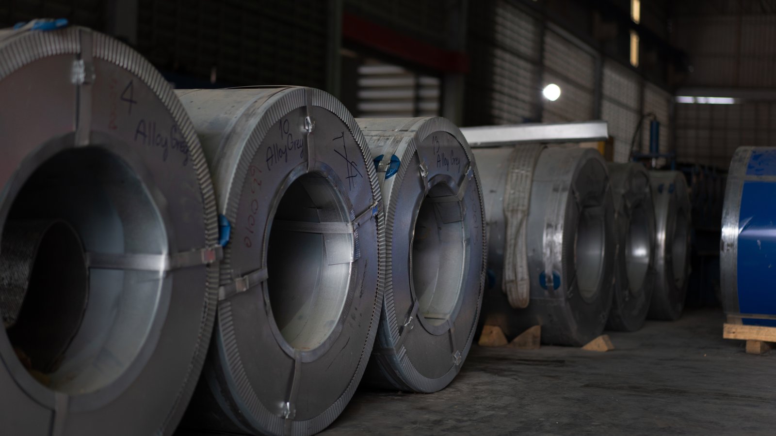 Various stainless steel coils stored on pallets at MFY, highlighting flexible inventory and raw material diversity