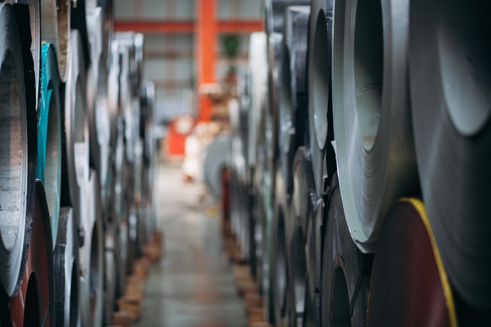 Aisle view of stainless steel coils in MFY’s warehouse, demonstrating capacity, material variety, and organized distribution