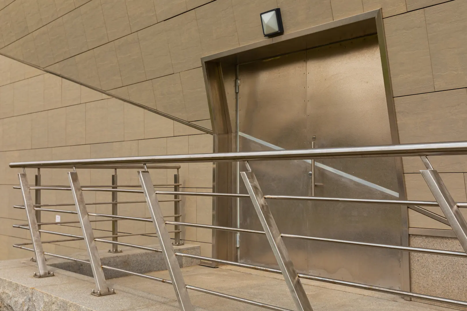 Sleek stainless steel railing and door in modern building design