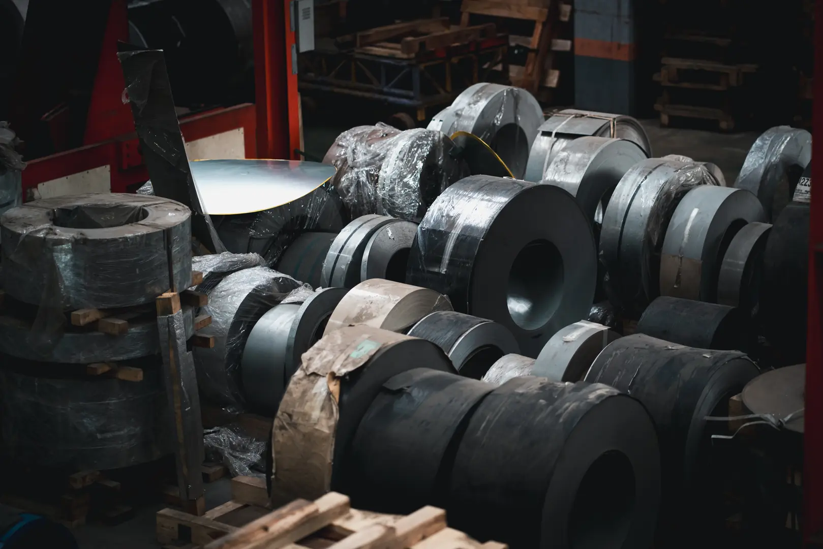 Collection of premium stainless steel coils stacked in a warehouse, showcasing MFY's high-quality metal products.
