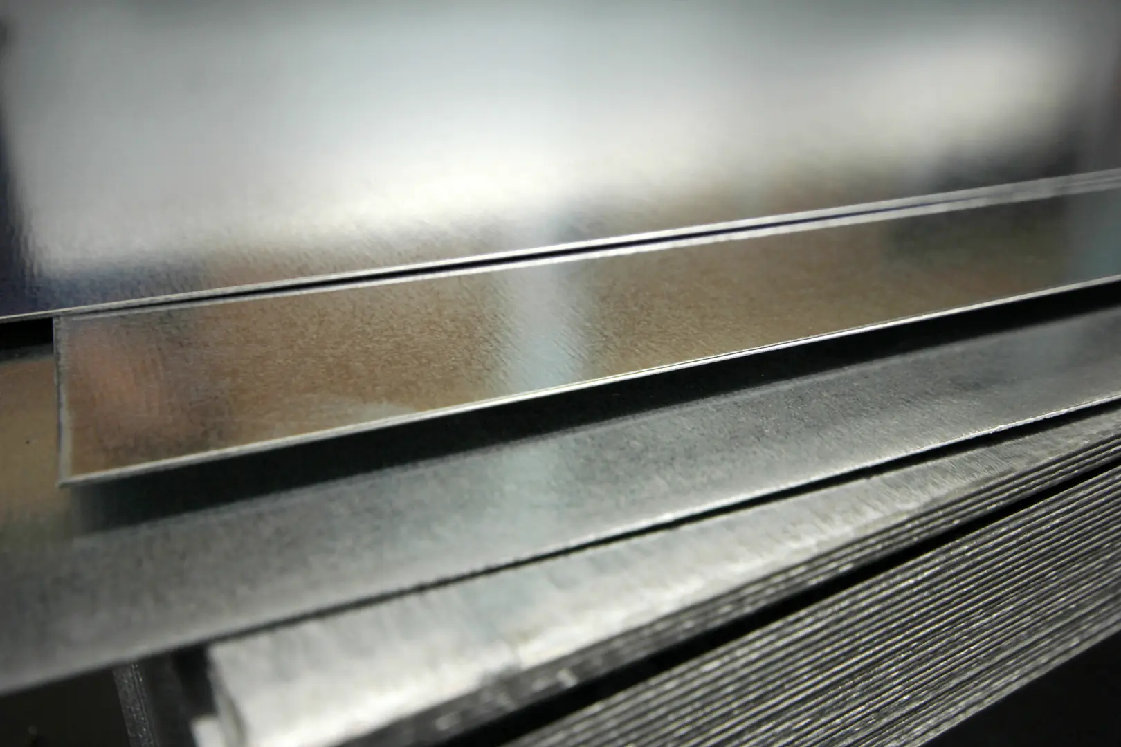 Close-up of polished stainless steel sheets, showcasing high-quality surface finish for industrial applications.