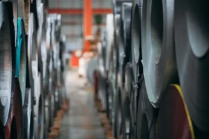 Rows of stainless steel coils in a warehouse representing MFY's supply chain efficiency